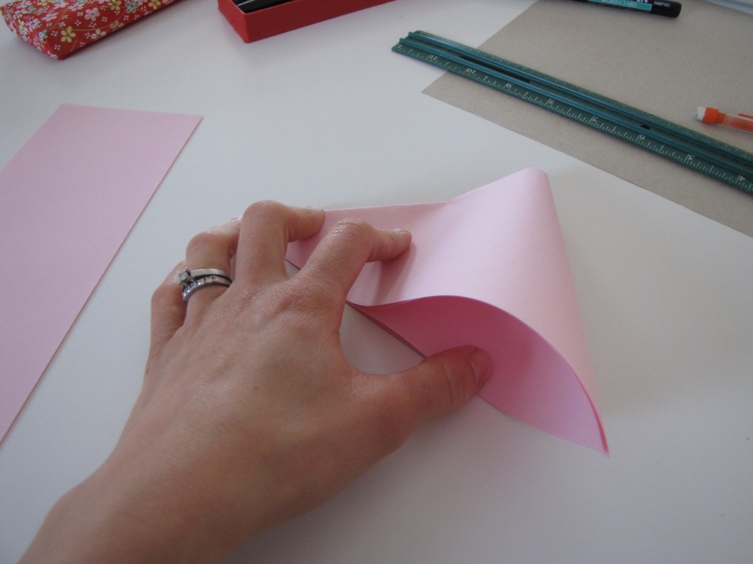 Fold to make a smaller triangle.