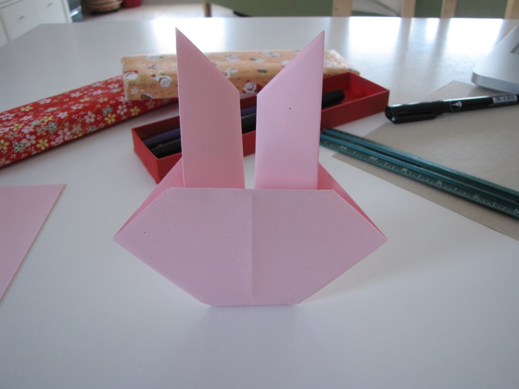 Your bunny just needs a face now. Notice that the last fold acts as a stand.