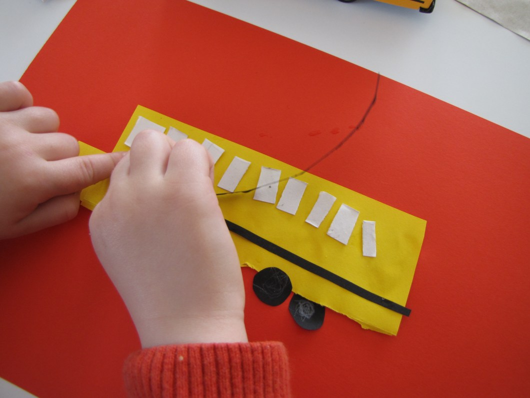 put your bus together by adding windows, black lines and wheels