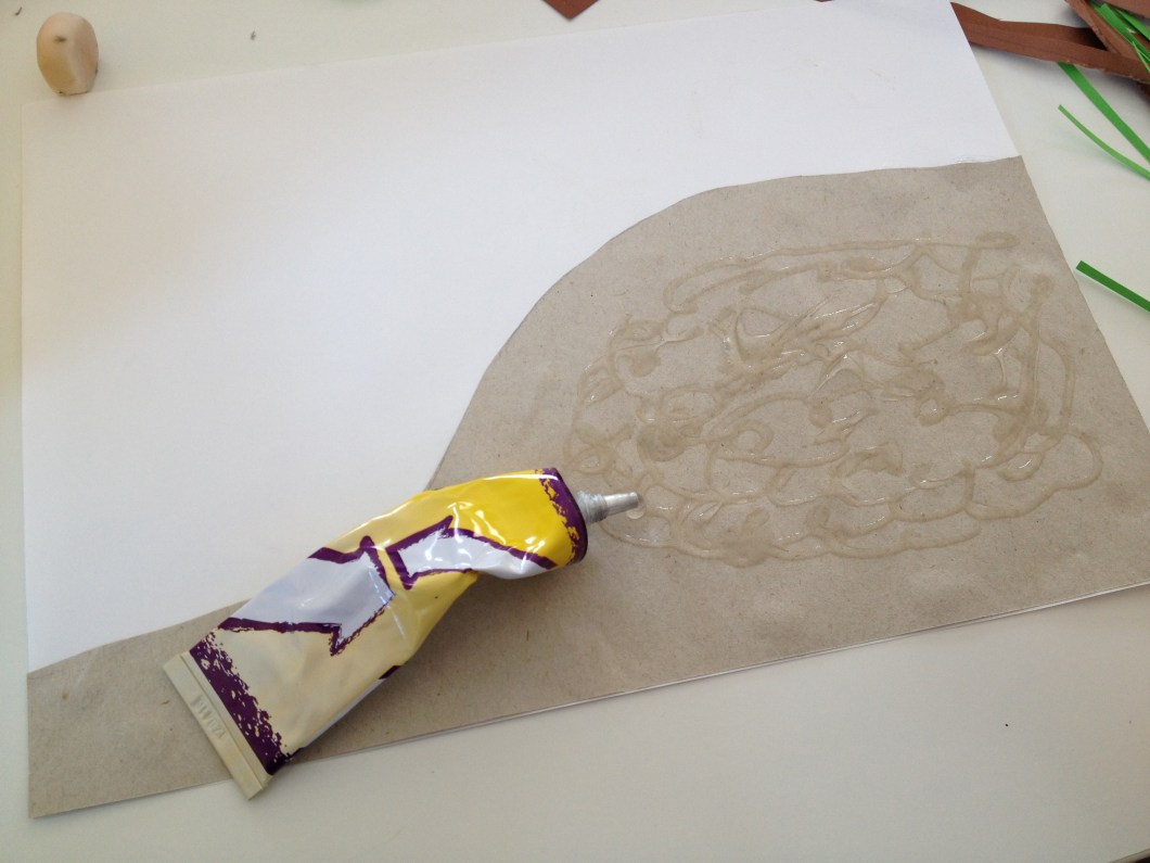 Add glue to the middle of your nest. That's where the sticks and grass will be placed.