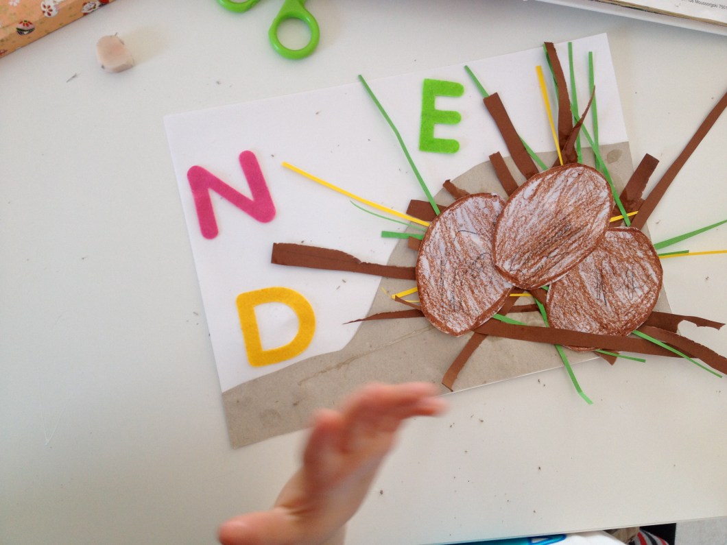 Add your dinosaur eggs and the letters D,N and E for dinosaur, nest and eggs.