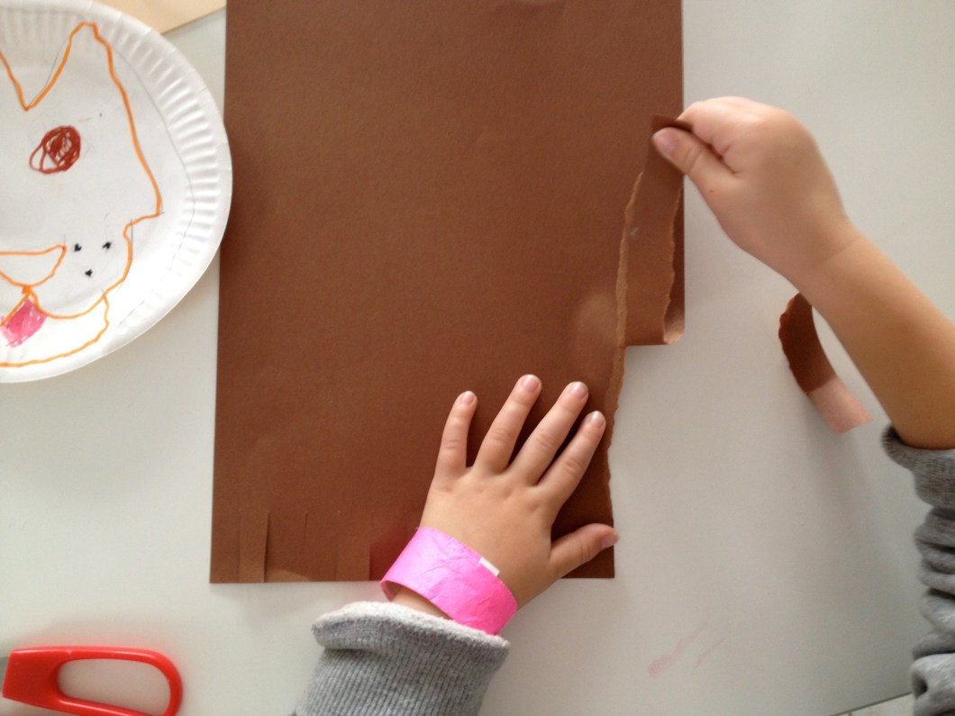 tear up long strips of paper to make his mane