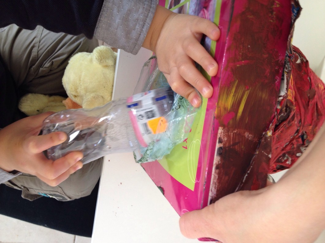 Flip the box over and pull out the plastic bottle.