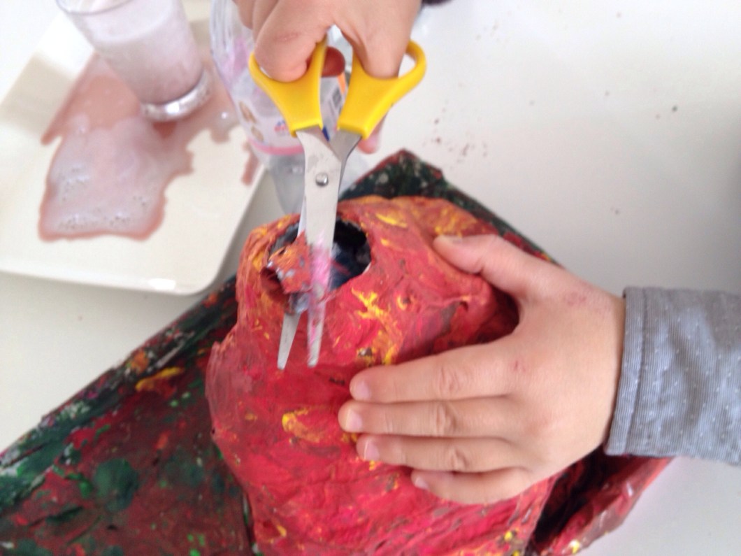 Cut off the plastic from the tip of your volcano.