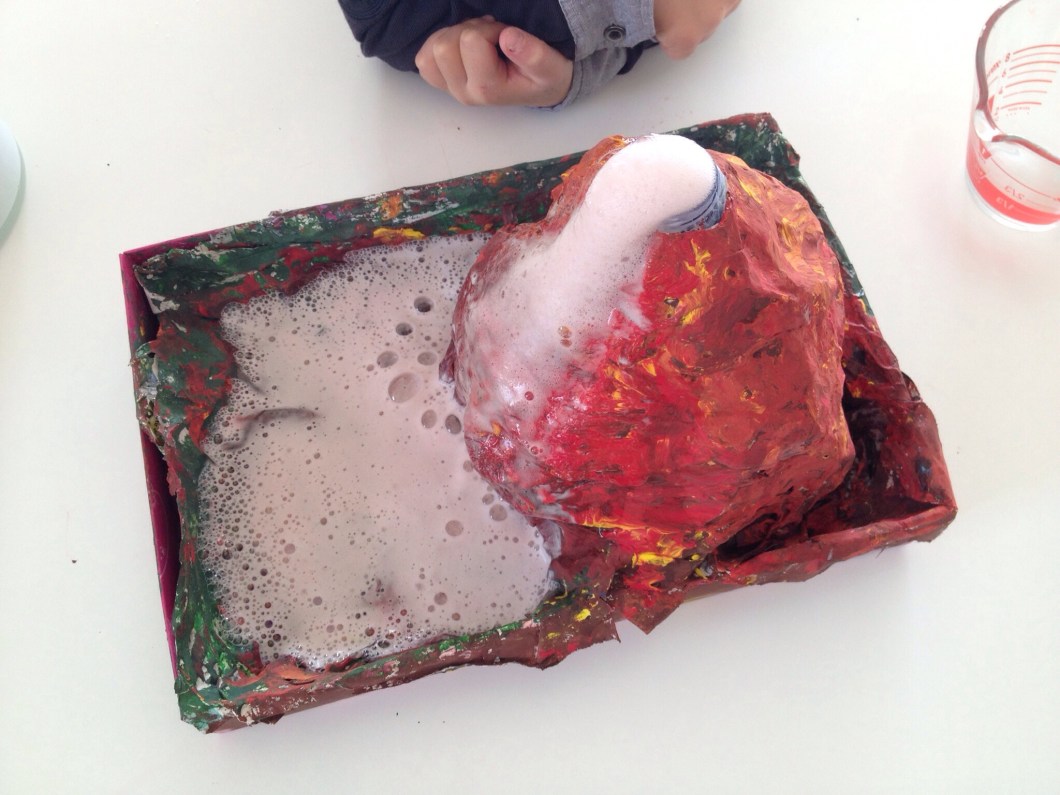 Pour about half a cup of vinegar into the bottle and watch as your volcano erupts!