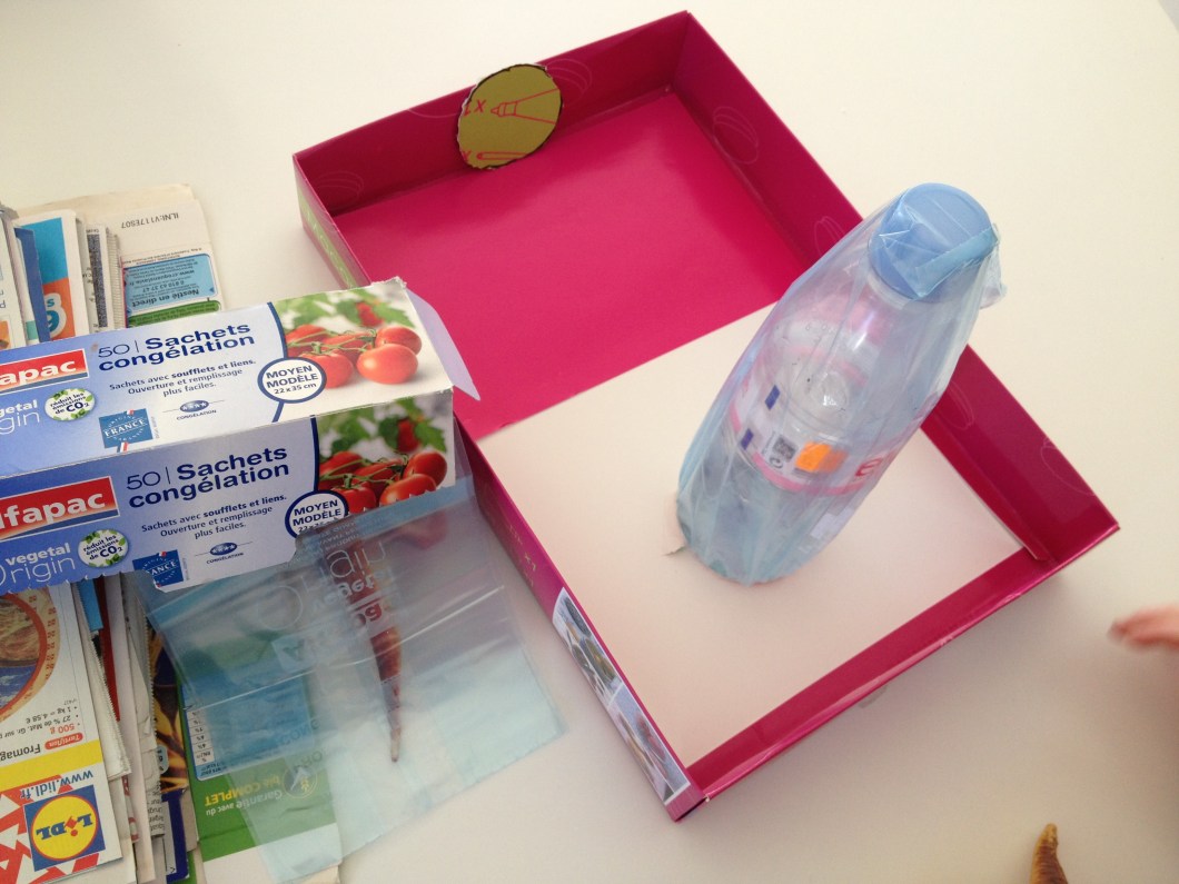 Cover the bottle with a plastic bag so that it doesn't stick to the paper mache.