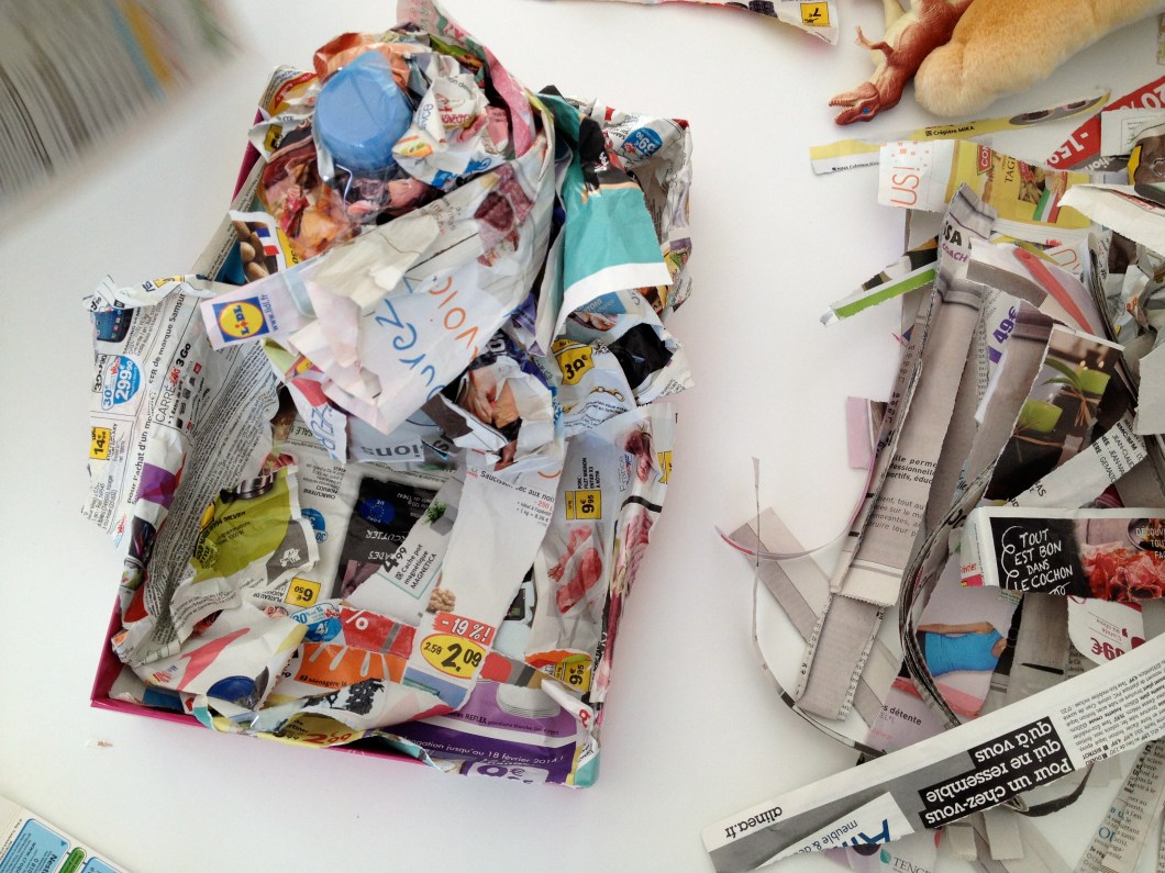 Shape your volcano with bunched up paper (newspaper or magazines will do) and use tape to keep the paper in place.