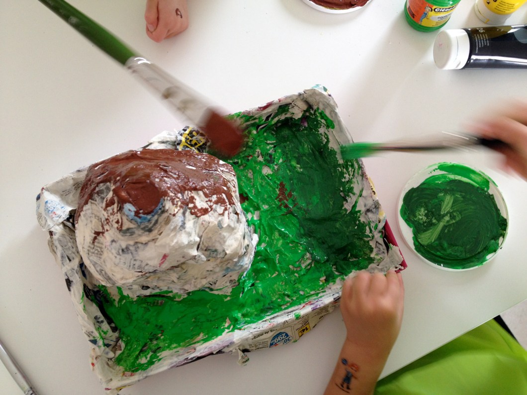 Paint your volcano in greens and browns first.