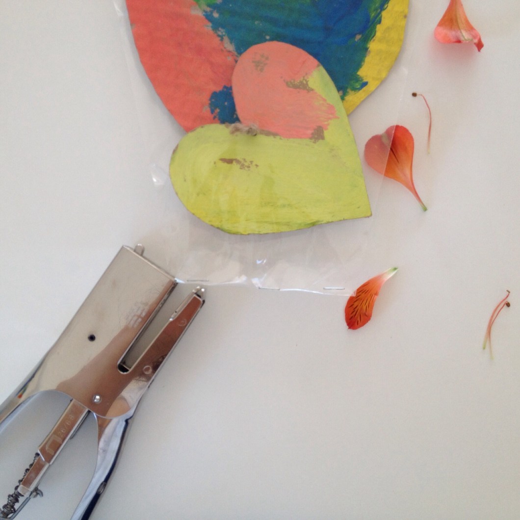 Use a stapler to seal the bottom (cut off some cellophane from the bottom if you need to).