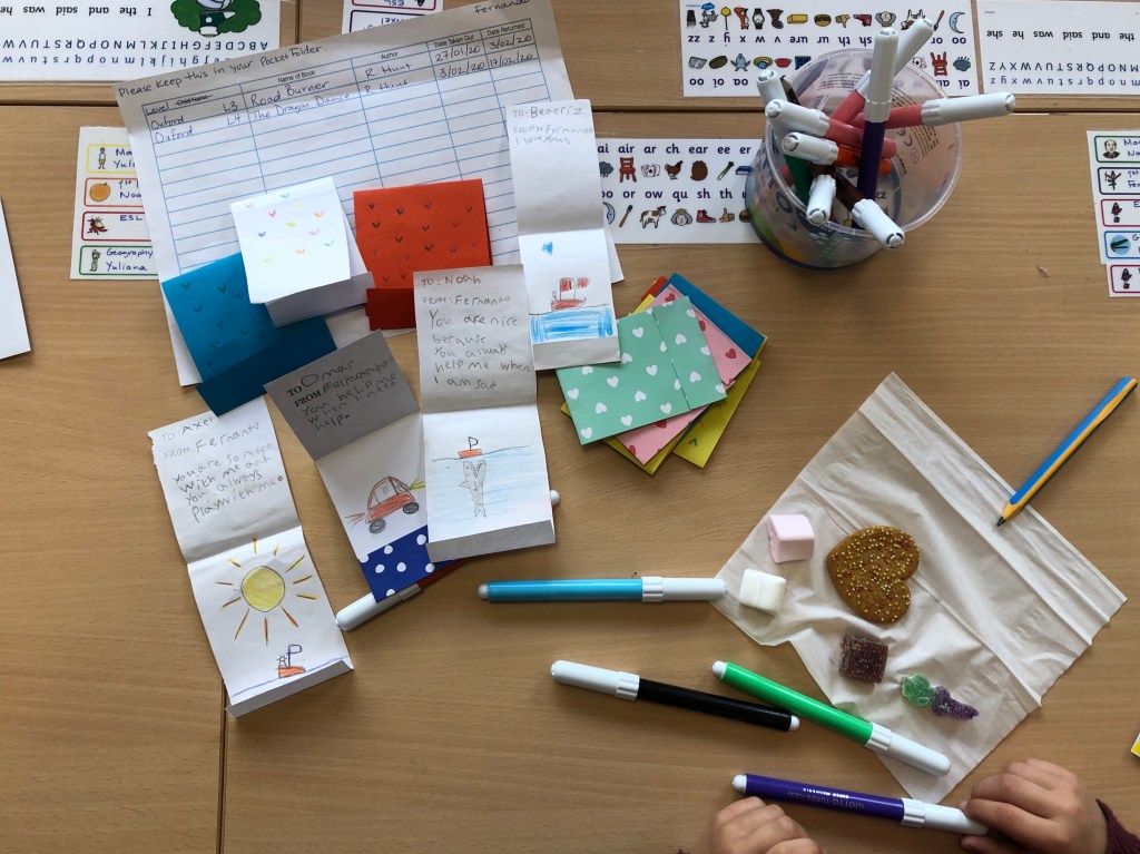 ESL conversation questions for Valentine's Day are used to make cards for classmates. This photo shows some cards with personal messages and decorations.