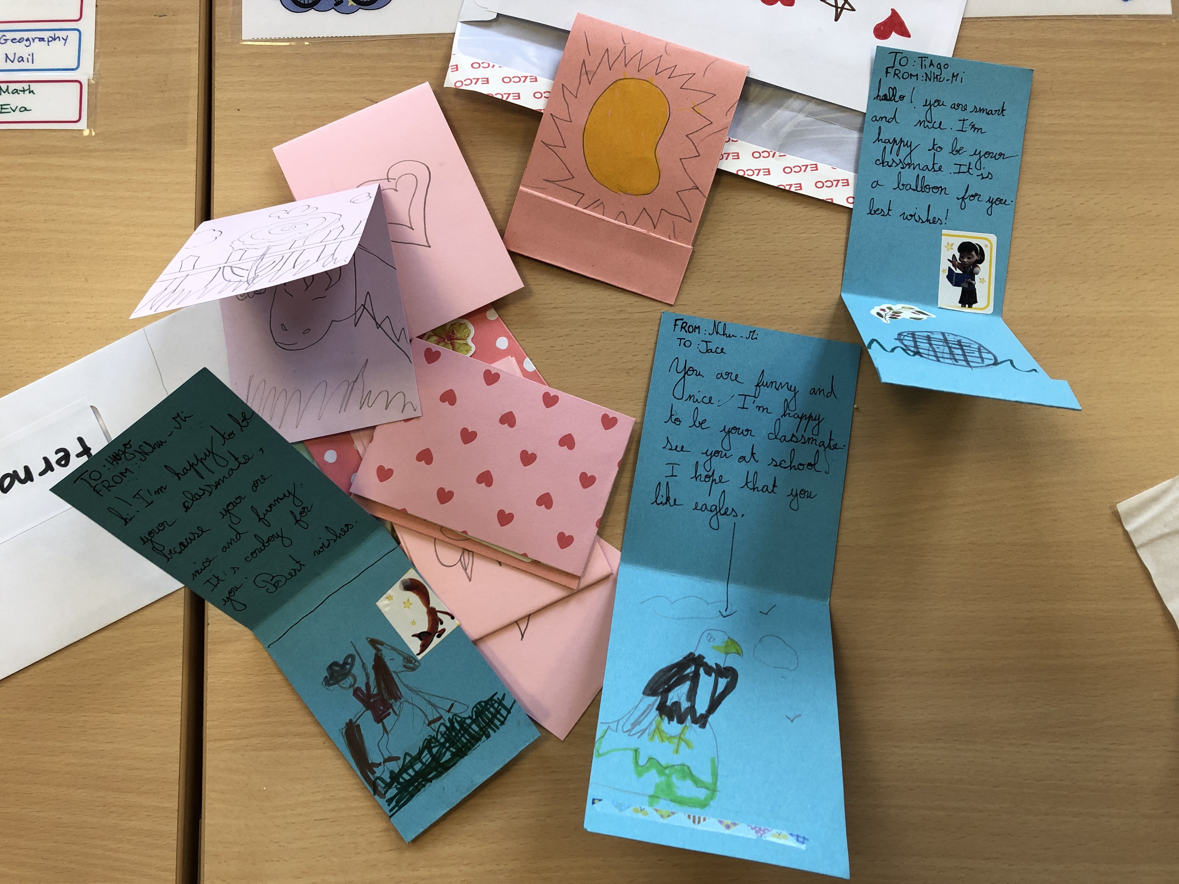 ESL conversation questions for Valentine's Day are used to make cards for classmates. This photo shows some cards with personal messages and decorations.