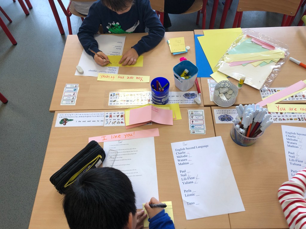 ESL conversation questions for Valentine's Day are used to make cards for classmates. This photo shows some cards with personal messages and decorations.