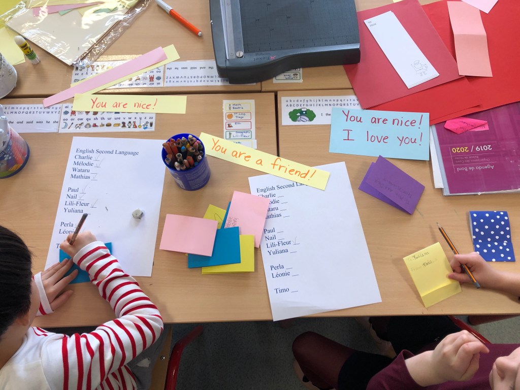 ESL conversation questions for Valentine's Day are used to make cards for classmates. This photo shows some cards with personal messages and decorations.