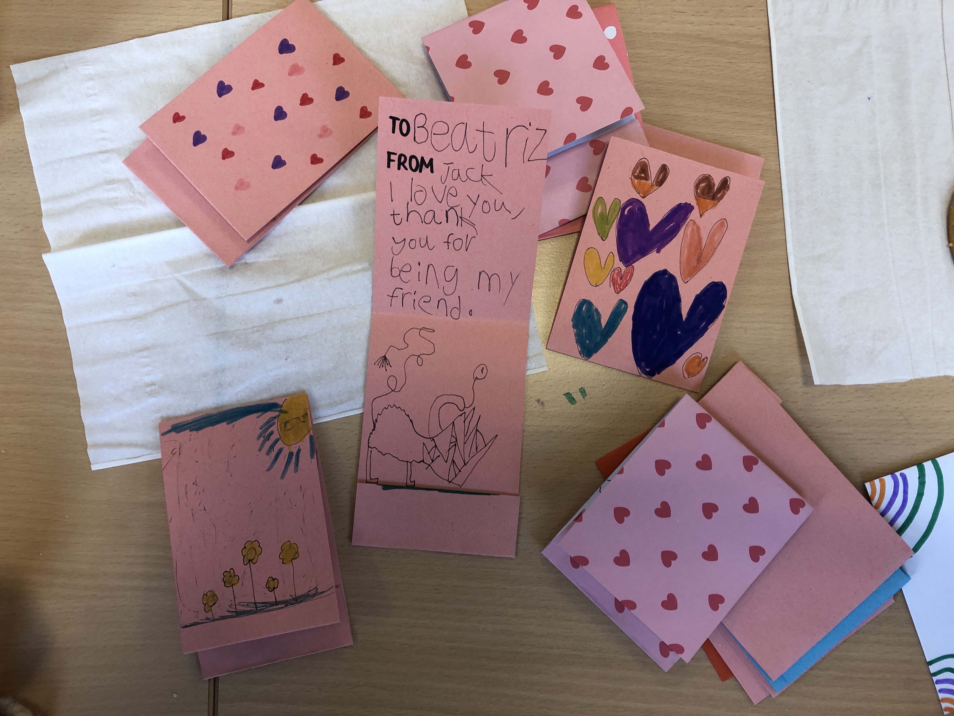 ESL conversation questions for Valentine's Day are used to make cards for classmates. This photo shows some cards with personal messages and decorations.